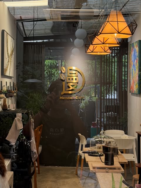 Mended Cafe seating, warm pendant lights and cafe signage